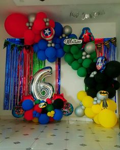 mickey mouse balloons are on display in front of the number six balloon arch for a 6th birthday party