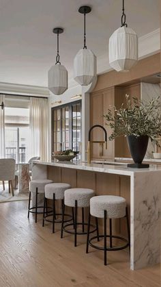 a kitchen with lots of counter space and stools next to an island in the middle