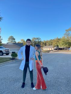 a man and woman standing in the middle of a parking lot