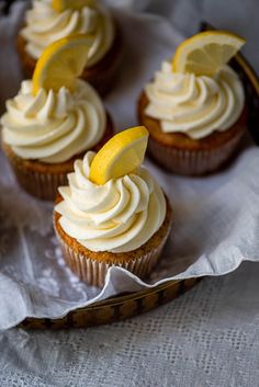 some cupcakes with lemon slices on top of them