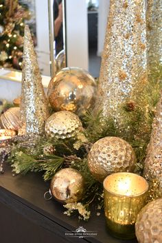 gold and silver christmas decorations on a mantle