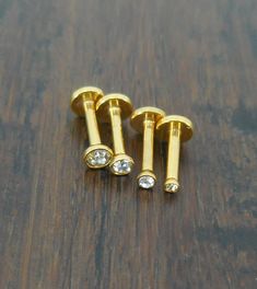 Metal: 16G Gold Tone Titanium Plated Gemstone Type: 1.5,2,2.5,3mm Cubic Zirconia Size / Style: 16G 1/4" (6mm) Cartilage, Flatback Triple Forward Helix Earrings This a set of triple forward helix rings in a gold plated finish.  Gold is a very popular color and these clear stones are a great color match.  I have 4 stone sizes available 1.5mm, 2mm, 2.5mm and 3mm.  You can select the size you would like or purchase all 3 or 4.  These are internally threaded for comfort. This style of piercing is ver Helix Rings, Triple Forward Helix, Triple Helix, Forward Helix Earrings, Helix Ring, Earrings Cartilage, Gold Lips, Forward Helix, Ring Earring