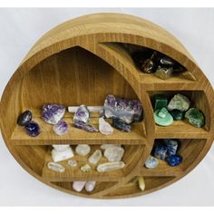 a wooden shelf filled with lots of rocks