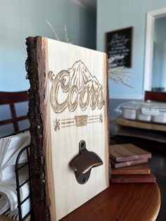 a wooden sign with the word coors on it sitting on top of a table