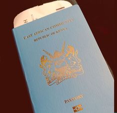 a blue passport sitting on top of a table