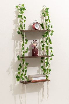 three shelves with plants and decorations on them