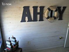 the word ahoy written in large letters above a life preserver on a wall