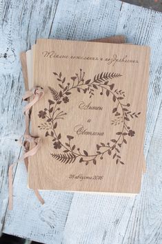 a wooden wedding guest book with a ribbon tied around it