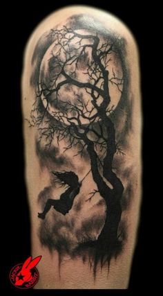 a black and white tattoo with a tree on it