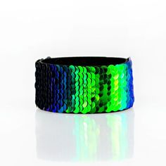 Lead & Nickel Free. Row After Row Of Shimmery Sequins Are Stitched Across The Front Of A Black Suede Band. Bracelet Features Reversible Sequins That Change From Black To Blue Multicolor. Features An Adjustable Snap Closure. Adjustable Blue Cuff Bracelet For Party, Green Cuff Bracelet For Party, Adjustable Green Cuff Bracelet For Party, Adjustable Green Cuff Bracelet For Parties, Adjustable Iridescent Bracelet For Parties, Beach Wedding Red, Orange Bracelet, Feather Bracelet, Purple Bracelet