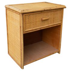 a wicker side table with drawers on one end and an open drawer on the other