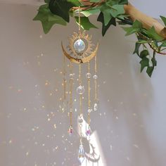 Transform your space with the Handmade 40cm Golden Moon Crystal Suncatcher 🌙--a mesmerizing addition to your home or garden that enchants with its elegance and mystique. Here's why this exquisite piece will capture your heart: ✨ Dazzling Design: Meticulously crafted with premium gemstones 💎 and healing crystals, radiating opulence and serenity. 🌈 Mesmerizing Rainbow Maker: Witness sunlight dance through the crystals, casting vibrant, shimmering rainbows that breathe life and vibrancy into any setting. 🎁 The Perfect Gift: Whether for Christmas 🎄, birthdays 🎉, or to elevate your home decor 🏡, this stunning suncatcher is a thoughtful and enchanting crystal gift for women--bringing joy and beauty to any occasion. 🌟 Versatile Charm: Effortlessly transform your indoor sanctuary or outdoo Moon Phase Decor, Golden Moon, Crystal Suncatcher, Hanging Crystals, Rainbow Maker, Garden Ornament, Crystal Suncatchers, Moon Crystal, Handmade Gold