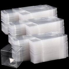 clear plastic boxes with dividers and lids on black background