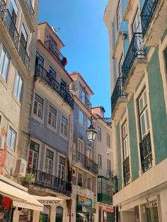 several buildings with balconies and people walking down the street