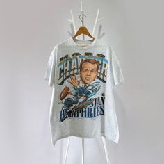 a t - shirt hanging on a clothes rack with an image of the character captain from star trek