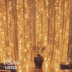 a living room filled with lots of lights next to a wooden table and couches