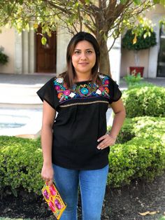 "We know there is no fiesta without the right outfit. This beautiful mexican blouse is handmade embroidered. So colorful and vibrant flowers. Will be perfect for your summer fiestas, or any boho-hippie style. Made of cotton Size: one size fits all Measurements: 17\" x 26\" This listing is for one BLACK mexican embroidered blouse All orders are shipped using Mexican Postal Service and it takes: 15-25 bussines days (North America). 20-30 bussines days (Europe). 20-35 bussines days (Rest of the wor Folk Style Blouse For Fiesta Festival, Embroidered Fiesta Blouse, Summer Fiesta Top With Geometric Embroidery, Summer Fiesta Tops With Embroidered Neckline, Fiesta Tops With Floral Embroidery, Multicolor Embroidered Top For Fiesta, Bohemian Embroidered Top For Summer Fiesta, Bohemian Embroidered Top For Fiesta In Spring, Multicolor Embroidery Tops For Fiesta