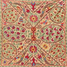 an intricately designed rug with red, green and blue flowers on the bottom corner