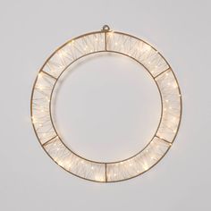 a circular light fixture with white lights in the middle and gold trimmings around it