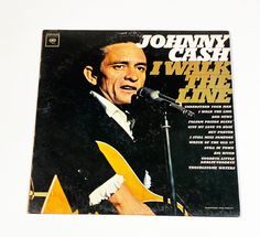 johnny cash i wake the line album cover with microphone and guitar in front of it