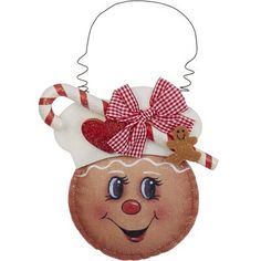 a christmas ornament with a ginger on it's head and a candy cane in its mouth