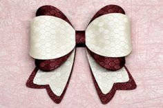 a red and white bow on a pink background