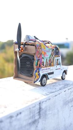 a toy van is sitting on top of a wall