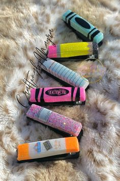 four different colored lighters laying on top of a furry surface