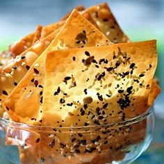 a glass bowl filled with crackers on top of a table