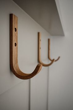 two wooden hooks are attached to the wall