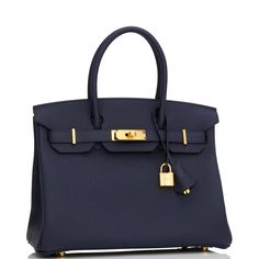 This Birkin is in Bleu Nuit togo leather with gold hardware and has tonal stitching, front flap, two straps with center toggle closure, clochette with lock and two keys, and double rolled handles. The interior is lined with Bleu Nuit chevre and has one zip pocket with an Hermes engraved zipper pull and an open pocket on the opposite side.Collection: ZOrigin: FranceCondition: Pristine; new or never (Plastic on hardware)Accompanied by: Hermes box, Hermes dustbag, clochette, lock, two keys, clochette dustbag, felt, carebook, rainhatMeasurements: 11.75" width x 9.5" height x 6" depth; 4.25" handle drop Birkin 30, Hermes Birkin 30, Hermes Box, Togo Leather, Hermes Birkin, Handbag Backpack, Tote Handbags, Gold Hardware, Luxury Bags