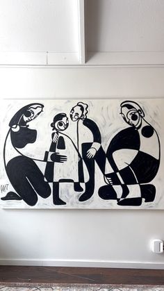 a black and white painting hanging on the wall