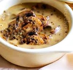 a white bowl filled with soup on top of a table