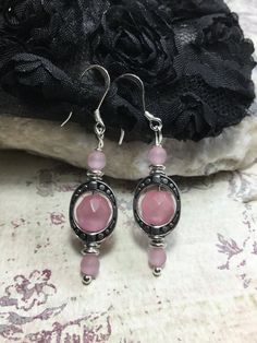 "So Delicate And Pretty These Pink Cats Eye Earrings. Made With, 4mm. Round Matte Pink Cats Eye Stone, 8mm Faceted Round Pink Cats Eye Stones, Antique Silver Plated Ovals, Sterling Silver French Hook Ear Wires And Silver Plated Ball Head Pins. If You Have An Idea For Another Stone Please Let Me Know. Any Item In My Shop Can Be Altered Or Substituted. Cat's Eye acts to stimulate intuition and to enhance awareness. It is a grounding stone that provides a very effective protective energy. Cat's Eye Hypoallergenic Round Spiritual Earrings, Spiritual Round Hypoallergenic Earrings, Spiritual Hypoallergenic Round Earrings, Adjustable Silver Oval Earrings, Pink Sterling Silver Round Earrings, Pink Round Sterling Silver Earrings, Silver Spiritual Hoop Earrings, Pink Sterling Silver Drop Crystal Earrings, Pink Sterling Silver Earrings For Pierced Ears