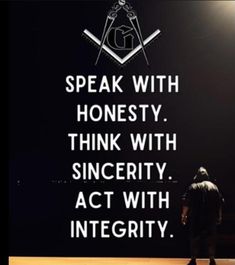 a man standing in front of a black wall with a quote on it that says speak with honesty, think with sincerity, act with integity