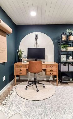 a home office with blue walls and white carpeted flooring, along with a computer desk