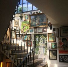 a staircase with many pictures on the wall