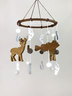 a wooden deer mobile hanging from a chandelier