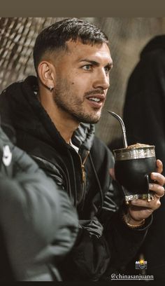 a man holding a drink in his hand