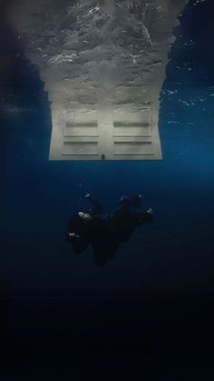 a man swimming under water in the ocean