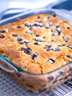 a blueberry dessert in a glass dish on a cooling rack