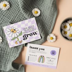 a thank you card and some daisies on top of a pink table with a note