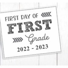 the first day of school sticker is shown on a white wooden background with an arrow