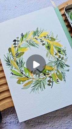 a video showing how to paint a wreath with watercolors