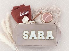 "Personalized Make Up Bags are a great gift for the bride-to-be, bridesmaids, bachelorettes, or any friend who likes pretty things! Each nylon pouch has a gold zipper and is lettered with chenille patches in the name or letters of your choice. Choose from a Natural, Taupe, Blush, or Black bag. Details This listing is for 1 Nylon Pouch with chenille patches Patch Placement: If you select 1 patch it will be placed at the bottom right. If you select 2 or more patches it will be centered. Size of Ba Monogram Cosmetic Bag, Custom Makeup Bags, Custom Makeup, Make Up Bags, Travel Toiletry Bag, Birthday Gifts For Teens, Bachelorette Party Favors, Christmas Gifts For Friends, Friend Christmas