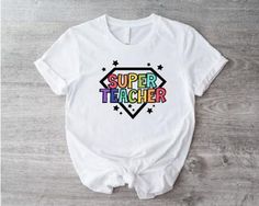 Super Teacher T-shirt, Best Teacher Shirt, Hero Teacher Tee, First Teacher's Day T-shirt, Back To School Shirt, Teacher Appreciation Gift 1. Check our photos for sizing and color options.  2. Choose your quantity. Feel free to add as many shirts as you wish!  3. Select your size and color from the drop-down menus.  4. Click "ADD TO CART" to add the shirt to your virtual cart.  5. Click "PROCEED TO CHECKOUT" to purchase your shirt.  6. Your shirt is now off to production! We will process your order and your shirt will be ready for shipment in 1-4 days!  **SHIRT SIZING** All of our shirts come in a variety of colors and many different sizes! **PROCESSING & SHIPPING** Your order should take approximately 3-7 business days to arrive at your door! Generally, the process and shipping time is as Trendy T-shirt With Heat Transfer Vinyl And Crew Neck, Graphic Tee With Screen Print For Teacher Appreciation, Casual White T-shirt For Teacher Appreciation, Trendy Cotton T-shirt With Heat Transfer Vinyl, White Fun T-shirt With Heat Transfer Vinyl, Fun White T-shirt With Heat Transfer Vinyl, Funny Cotton T-shirt With Heat Transfer Vinyl, White Crew Neck T-shirt For Teacher Appreciation, Fun Graphic Print T-shirt For Teacher Appreciation