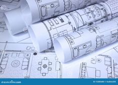 rolls of architectural drawings on top of blueprints stock photo - image 399874