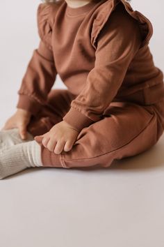 Rediscover our classic French Terry Sweatshirt for baby, with a signature ruffle sleeve. Available in three soft hues with ribbed trim and back snaps for easy on-and-offs, we love it pehr-ed with our French Terry Harem Pants or Essential Legging for a complete set! Made in 100% organic French Terry cotton, each piece of this collection is garment dyed for a vintage washed look and has the softest hand-feel. Organic Cotton & Dyes Brown Long Sleeve Tops For Playtime, Casual Playwear Tops With Ribbed Cuffs, Soft Cotton Tops, Relaxed Fit Tops For Playwear In Fall, Fall Tops With Elastic Cuffs, Bottom Clothes, French Terry, Harem Pants, Dress Shop