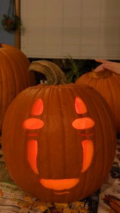 three pumpkins with faces carved into them