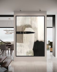 an abstract painting hangs in the dining room